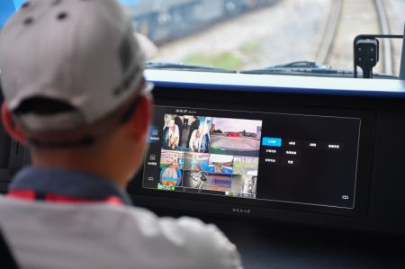 (miniature) Un employé vérifie la surveillance vidéo d'une locomotive électrique lourde intelligente à Zhuzhou