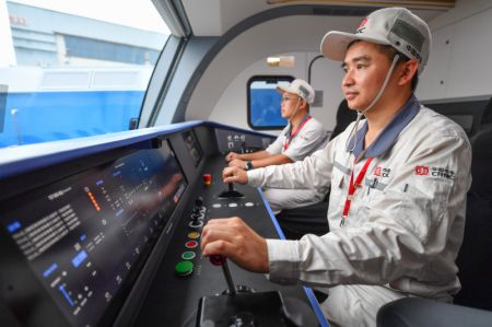 (miniature) Des employés vérifient les performance d'une locomotive électrique lourde intelligente à Zhuzhou